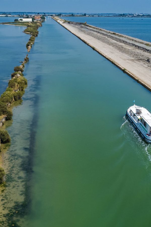 aerial-view-of-boats-in-canal-in-lagoon-of-mediterranean-sea-etang-de-thau-water-from-above-travel-by-barge-in-south-france