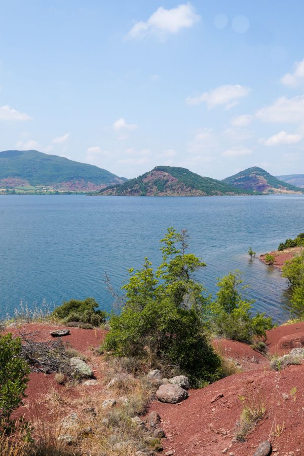 lac-du-salagou-water-calm-dusk-red-landscape-lake-coast-with-mountain-island-view-panorama