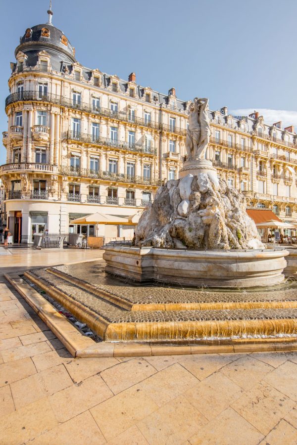 view-on-the-comedy-square-with-fountain-of-three-graces-during-the-morning-light-in-montpellier-city-in-southern-france